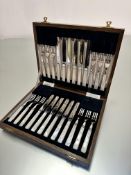 A set of twelve pairs of Epns mother of pearl handled fruit knives and forks in original oak
