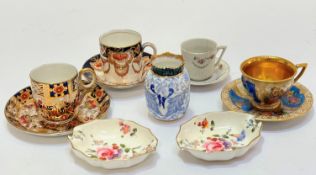 A Dresden porcelain miniature cup with figure and floral decorated panels with gilt reserves and