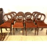 A matched set of twelve Victorian mahogany balloon back dining chairs, with upholstered seats and