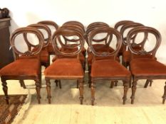 A matched set of twelve Victorian mahogany balloon back dining chairs, with upholstered seats and
