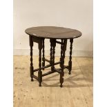 An oak gateleg table, early 20th century, the oval top raised on spiral turned and block supports,