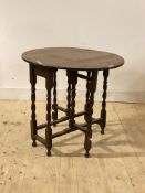 An oak gateleg table, early 20th century, the oval top raised on spiral turned and block supports,