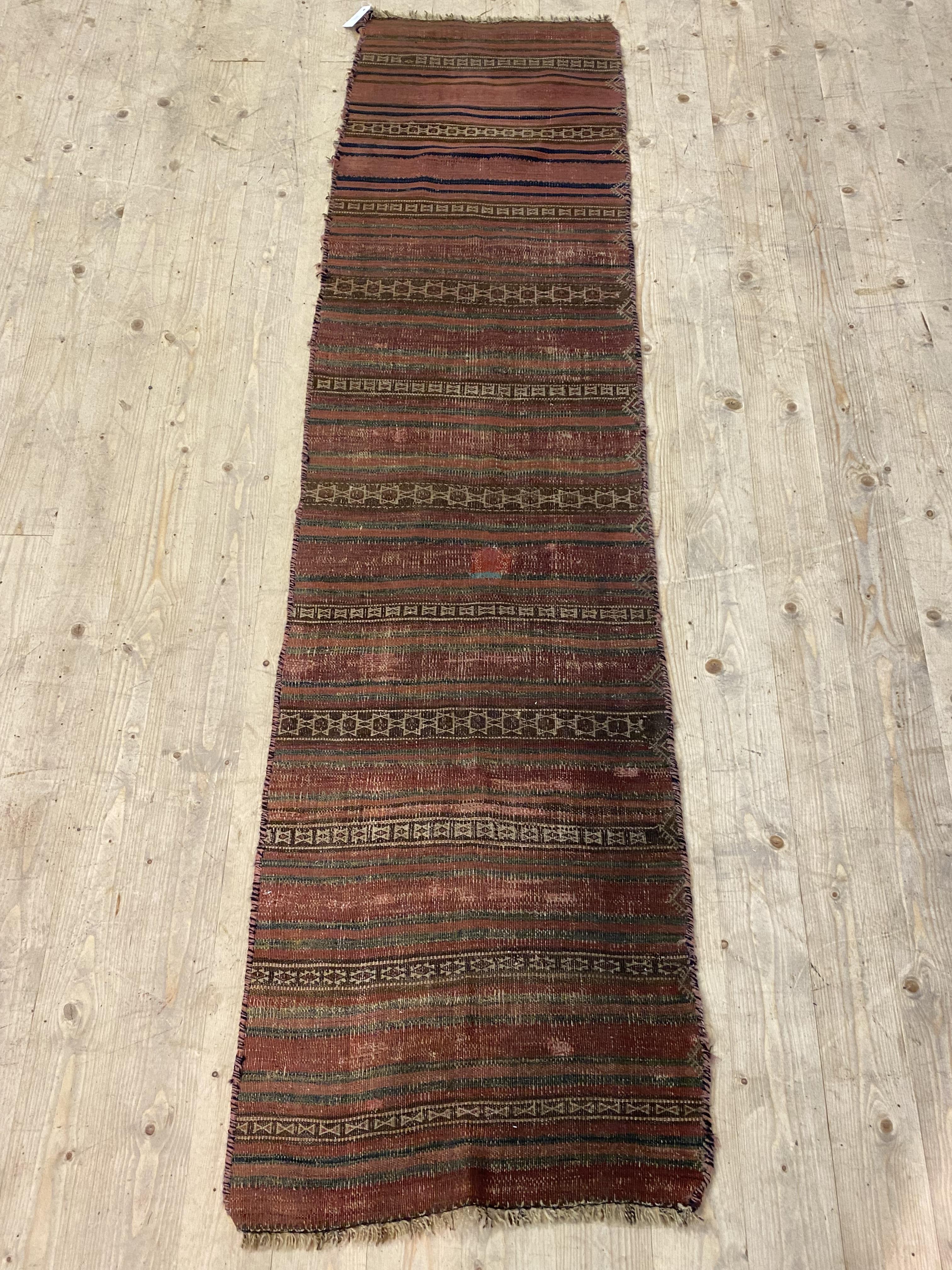 An old Caucasian flat weave runner rug of lineal design, 225cm x 57cm