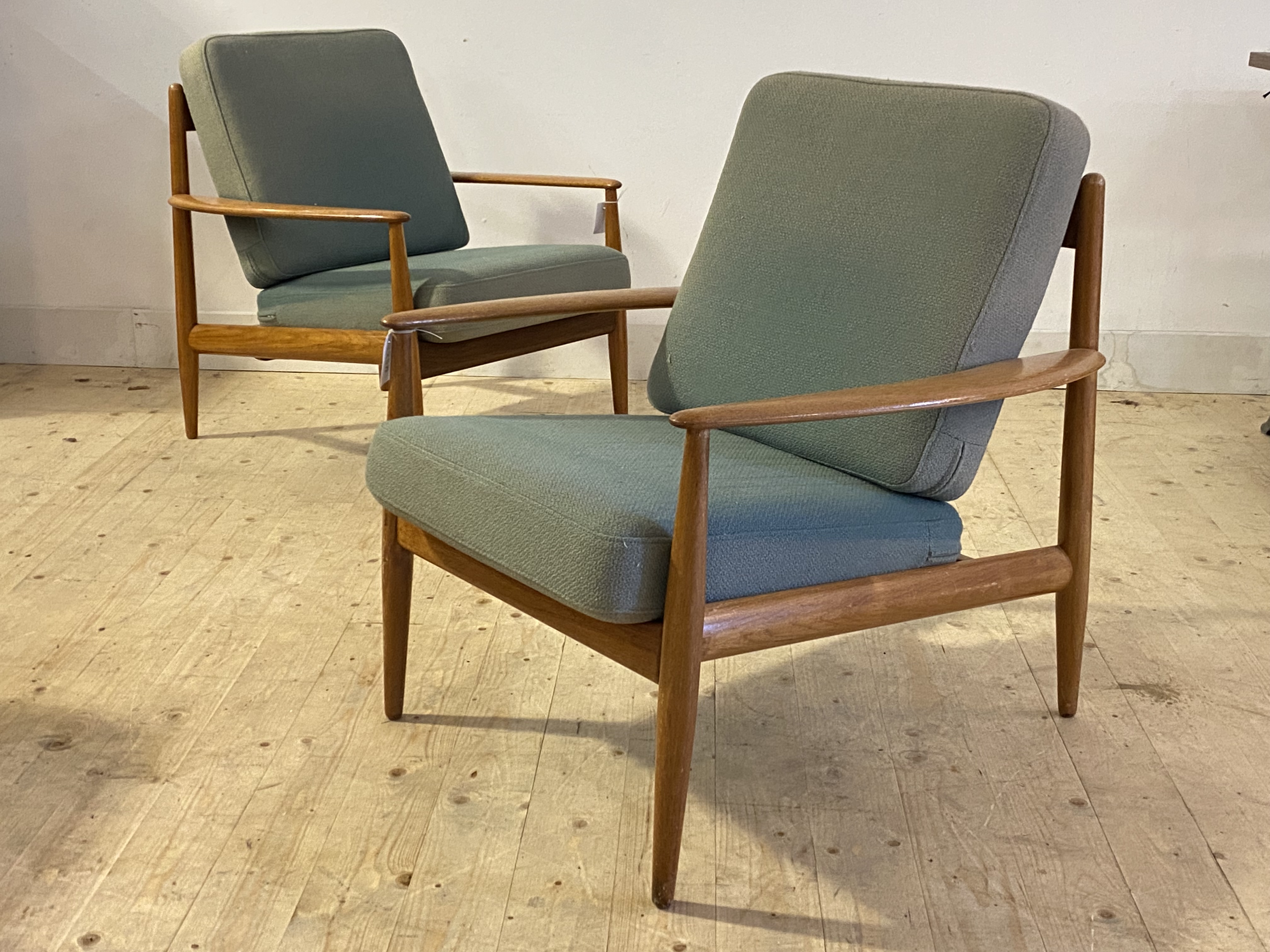 Grete Jalk for France & Son, A pair of Danish teak framed lounge chairs, with swept open arms