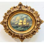 A reproduction oval panel of an English naval three masted ship, on a stormy sea, oil on panel, gilt