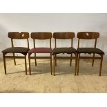 A set of four mid century teak dining chairs, with red vinyl upholstered seats, H73cm, W46cm, D44cm