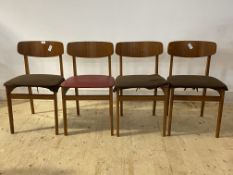 A set of four mid century teak dining chairs, with red vinyl upholstered seats, H73cm, W46cm, D44cm