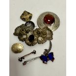 A white metal engraved plaid style brooch with amber glass centre claw set panel, (d 6cm), a brass