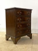 A Georgian style cross banded mahogany bedside chest, fitted with four drawers, raised on bracket