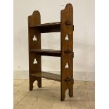 An early 20th century Arts and Crafts style open wall shelf, with three tiers raised on pierced