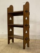 An early 20th century Arts and Crafts style open wall shelf, with three tiers raised on pierced