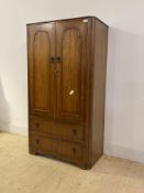 A 20th century walnut compactum wardrobe, the two panelled doors enclosing shelves, over two drawers