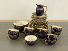 An Aynsley china blue and gilt part tea service, comprising 11 cups, 12 saucers, 12 side plate, milk