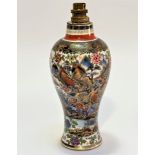 An English baluster china vase, decorated in Chinese style with chrysanthemums, figures and