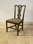 A George III mahogany dining chair, the shaped and floral carved crest rail over pierced splat back,