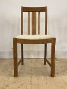 Heal's, an early 20th century oak chair, with spar back, drop in seat pad, raised on square