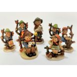 A collection of German Hummel pottery figures including three Apple Tree Boys, an Apple Tree Girl,