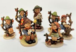 A collection of German Hummel pottery figures including three Apple Tree Boys, an Apple Tree Girl,