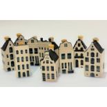 A set of nine KLM blue Delft Bols ceramic decanters in the form of Dutch merchants town houses, (