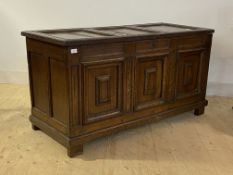 An 18th century oak coffer, the three panel top lifting to reveal a plain interior, with three