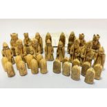 A cast composition set of Uig Isle of Lewis chess and draughtsmen complete with related