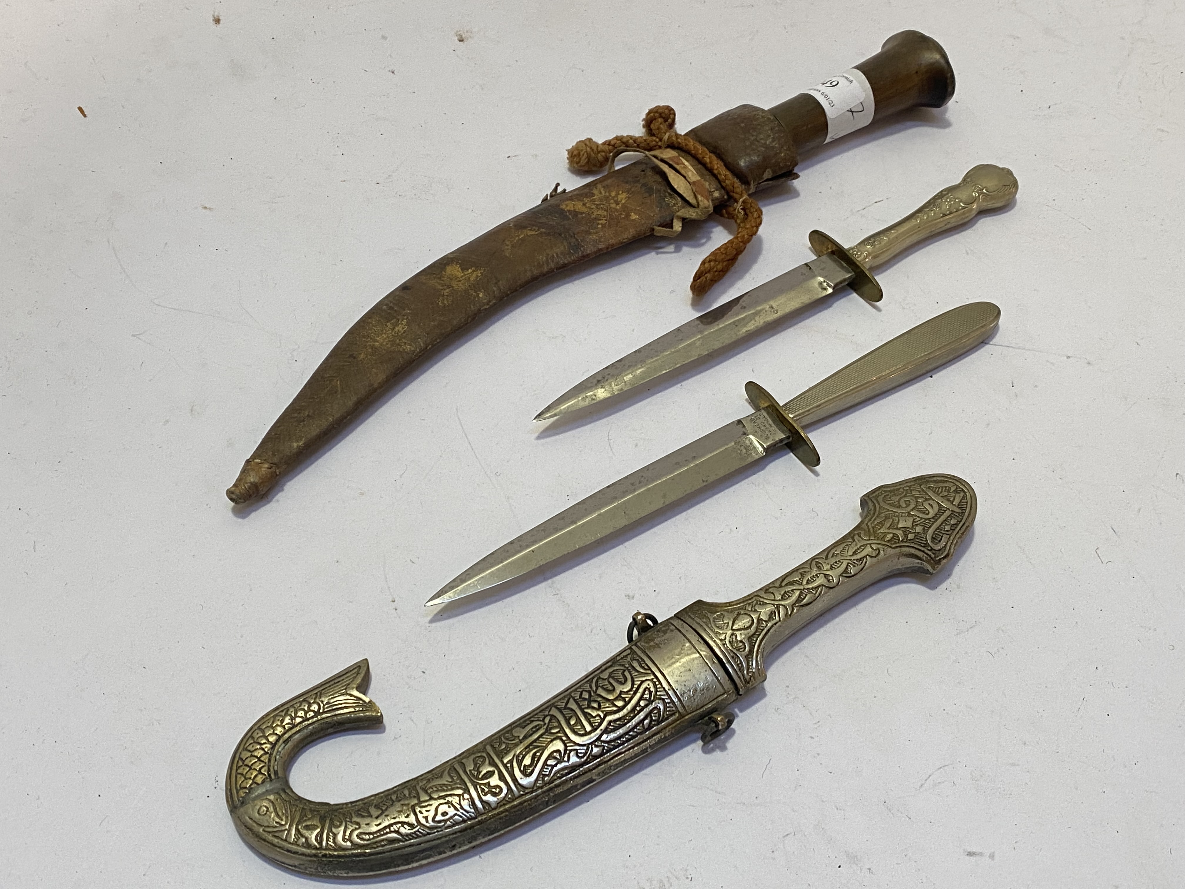 Knives and daggers: a wood and leather bound Eastern dagger with steel blade. Metal Jambiya and