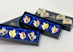 A set of eight Aynsley china floral decorated place name holders complete with boxes and four