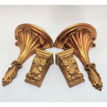 A pair of compressed paper gilt circular wall brackets with palm leaf style frond's tied with