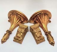 A pair of compressed paper gilt circular wall brackets with palm leaf style frond's tied with