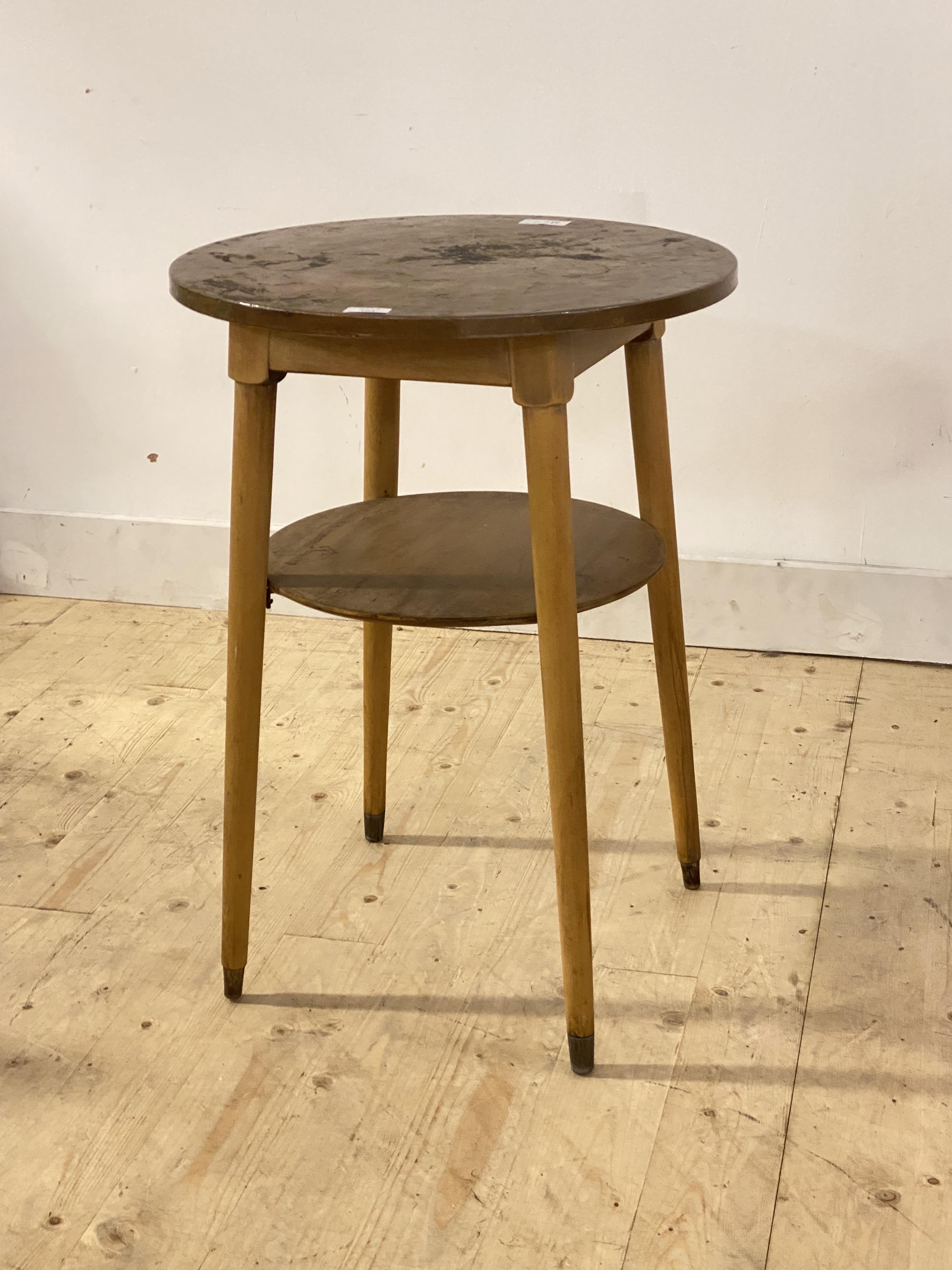 An early 20th century occasional table, the circular hammered copper top over turned beech