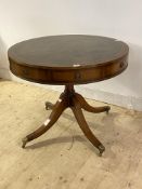 A Regency style mahogany drum table, the top inset with tooled leather writing surface, over four