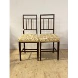 A pair of Edwardian inlaid mahogany bedroom chairs, with upholstered seat, raised on square