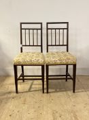 A pair of Edwardian inlaid mahogany bedroom chairs, with upholstered seat, raised on square