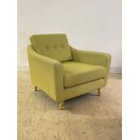 A contemporary easy chair, upholstered in buttoned lime green fabric, raised on turned supports,
