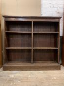 A late 19th/ early 20th century oak open bookcase, fitted with four adjustable shelves, raised on