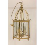 A gilt brass octagonal hanging lantern with inset glass panels, H65cm