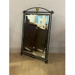 A cast and wrought metal wall hanging mirror, the bevelled plate enclosed by a frame finished in a