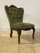 A Victorian style bedroom chair, the floral carved crest rail over buttoned back and raised on