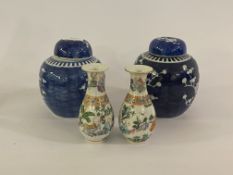 A pair of Chinese blue and white ginger jars with covers, with stylised crysanthemum tree design, (