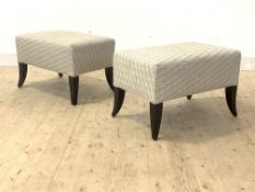 A pair of contemporary upholstered footstools, raised on splayed tapering supports, H47cm, W74cm,