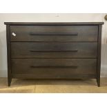 Andrew Martin, a stained wood chest, fitted with three drawers, raised on square tapered supports,