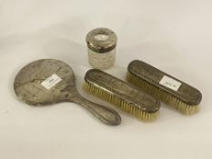 A An early 20th century silver mounted dressing table set including two brushes, a mirror and a