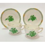 A pair of Herend Hungarian porcelain handpainted coffee cups with basket weave borders, decorated
