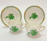 A pair of Herend Hungarian porcelain handpainted coffee cups with basket weave borders, decorated