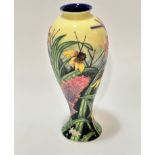 An old Tupton Ware baluster vase decorated with tube lined floral design on yellow ground, (26cm x