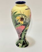 An old Tupton Ware baluster vase decorated with tube lined floral design on yellow ground, (26cm x