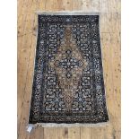 A Persian style silk pile rug, the ivory ground with stylised floral design enclosed by a border,