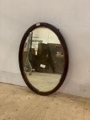 An Edwardian mahogany framed oval wall hanging mirror with bevelled glass 74cm x 54cm