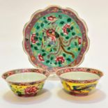 A pair of Chinese Famille Jaune scalloped miniature bowls decorated with exotic phoenix and