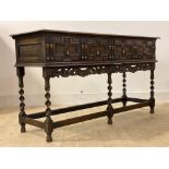 An oak dresser base or sideboard of 17th century design, circa 1930s, the top with moulded edge over